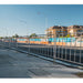 Metal crowd control barrier in silver color, ideal for outdoor events and construction sites.