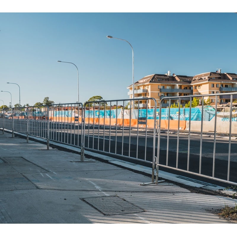 Metal crowd control barrier in silver color, ideal for outdoor events and construction sites.